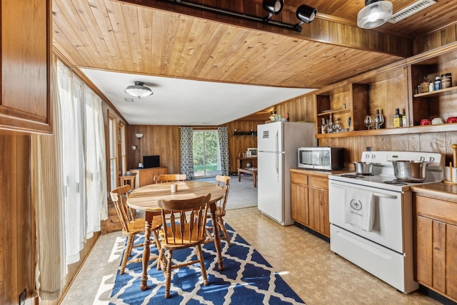 kitchen with open shelves, white appliances, wood walls, wooden ceiling, and light floors