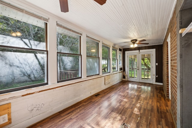 unfurnished sunroom featuring french doors, ceiling fan, and a wealth of natural light