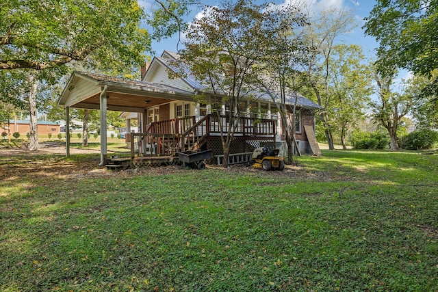 rear view of house with a yard and a wooden deck