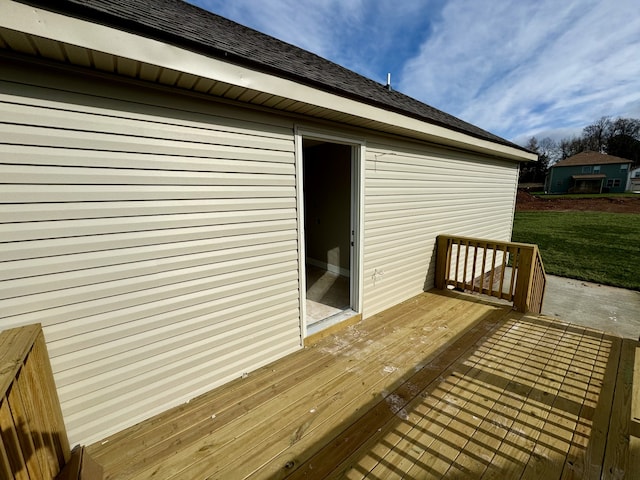 wooden terrace featuring a lawn