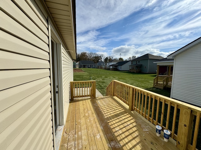 wooden terrace featuring a lawn