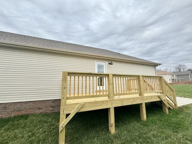 wooden deck with a lawn