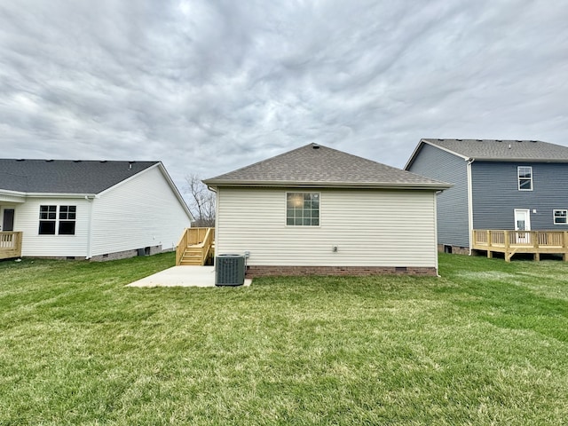 back of property featuring a lawn, central AC unit, and a deck