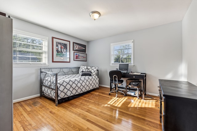 bedroom with hardwood / wood-style flooring