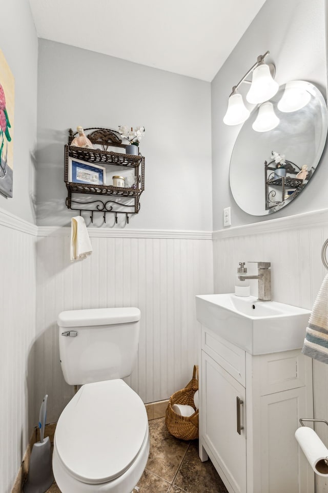 bathroom with vanity, tile patterned flooring, and toilet