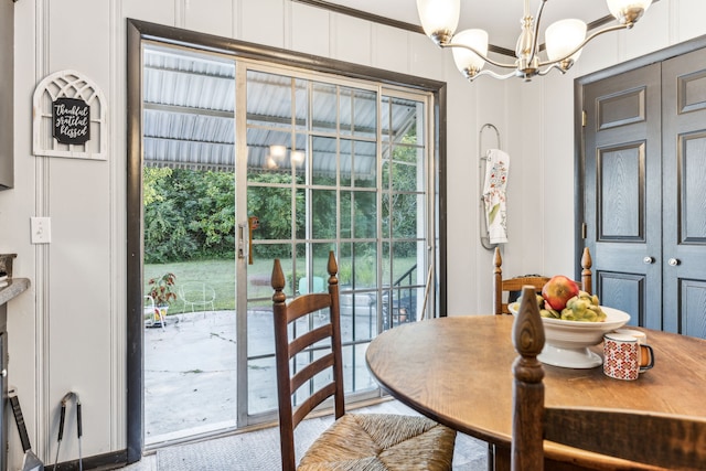 dining space featuring crown molding and an inviting chandelier