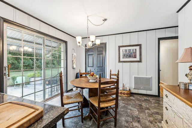 dining room featuring a notable chandelier and heating unit