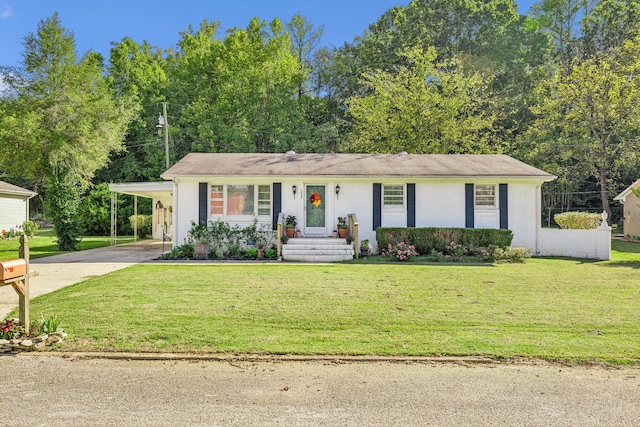 ranch-style home featuring a carport and a front yard