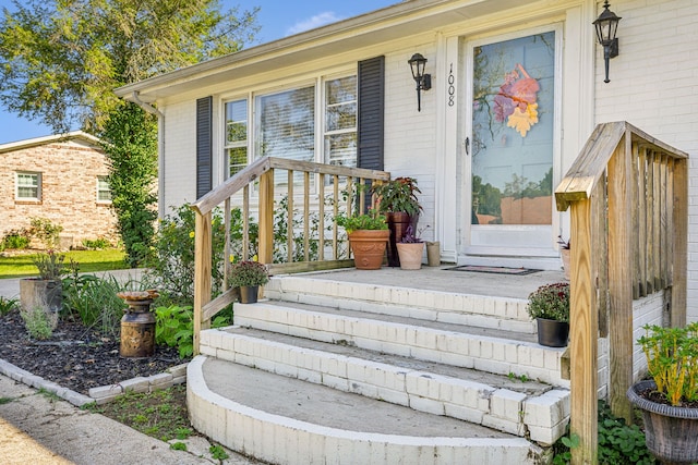 view of exterior entry featuring covered porch