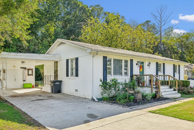 ranch-style home featuring a carport