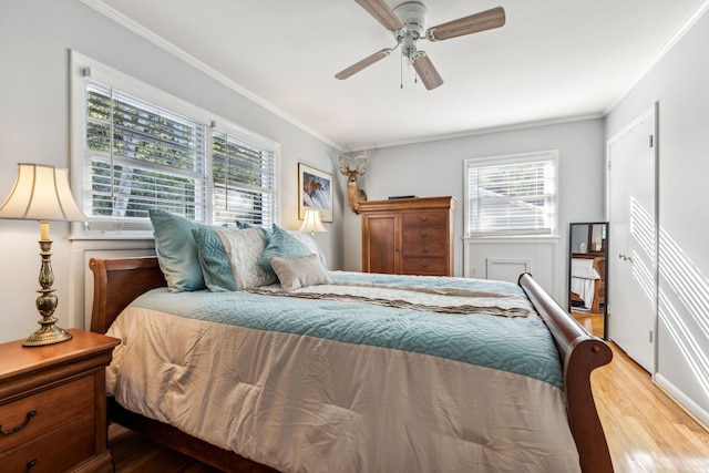 bedroom featuring ceiling fan, crown molding, light hardwood / wood-style floors, and multiple windows