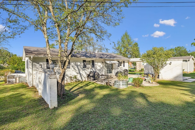 back of property with a lawn and a patio