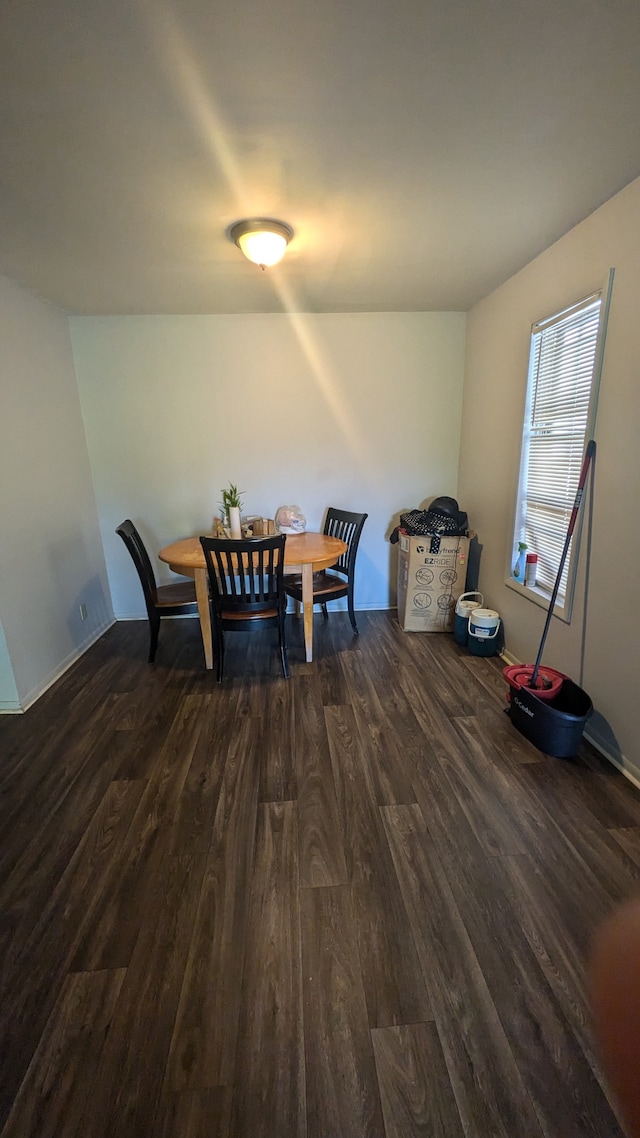 dining space with dark hardwood / wood-style flooring