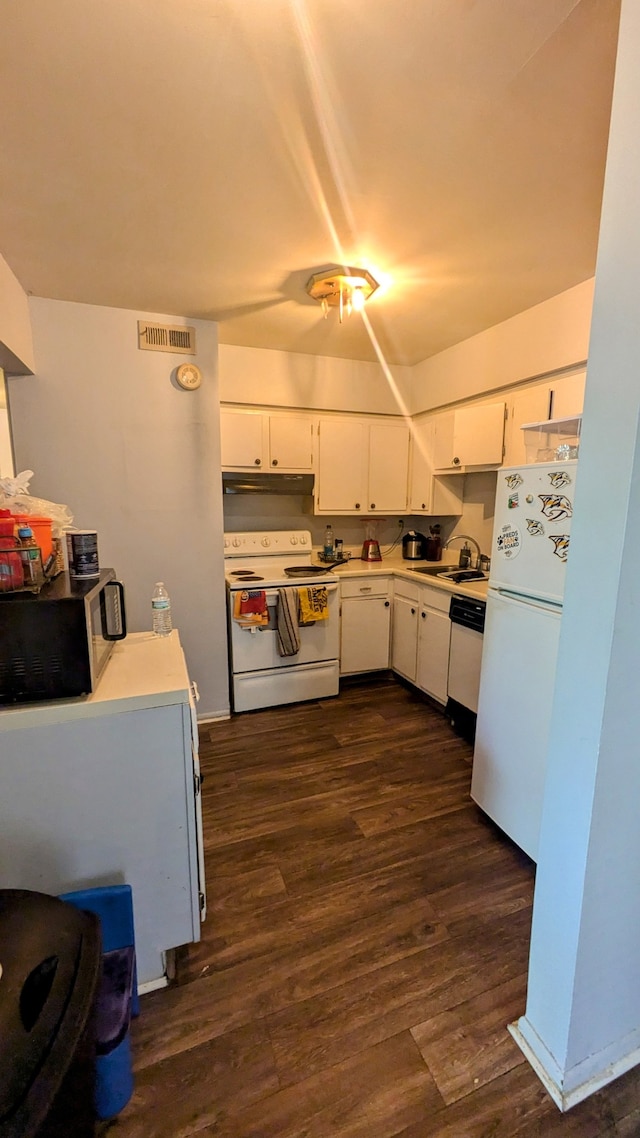 kitchen featuring dark wood-type flooring, sink, white appliances, and white cabinetry