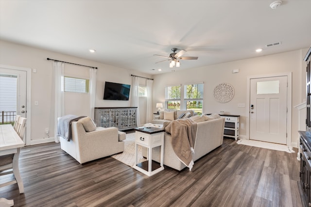 living room with ceiling fan and dark wood-type flooring