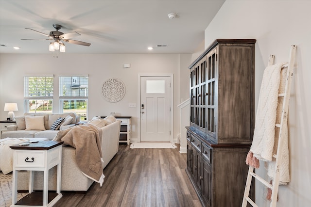 entrance foyer with ceiling fan and dark wood-type flooring