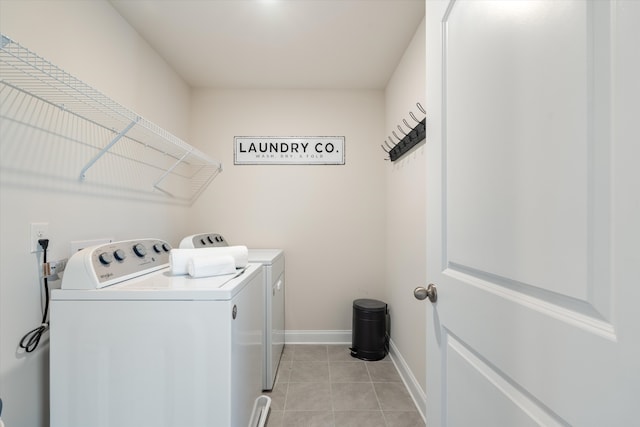 washroom with washing machine and clothes dryer and light tile patterned floors