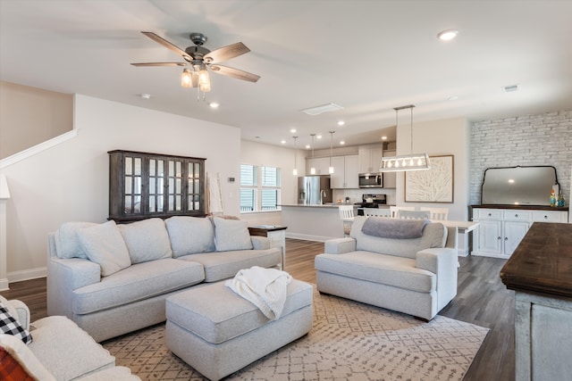 living room with ceiling fan and hardwood / wood-style flooring