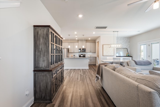 living room with ceiling fan and hardwood / wood-style floors