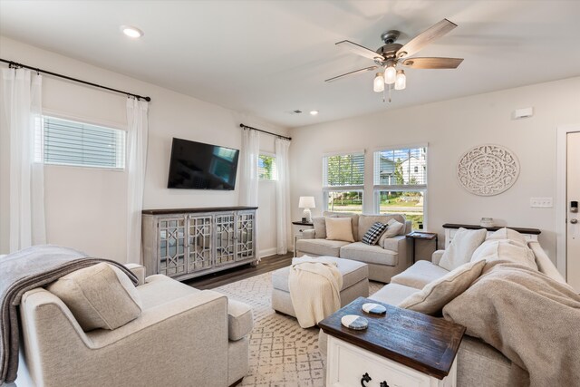 living room featuring light hardwood / wood-style flooring and ceiling fan