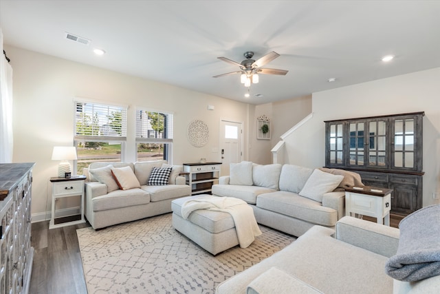 living room with wood-type flooring and ceiling fan