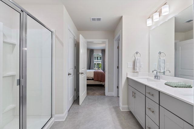 bathroom featuring vanity, an enclosed shower, and tile patterned floors