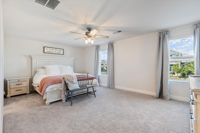 bedroom featuring light carpet and ceiling fan