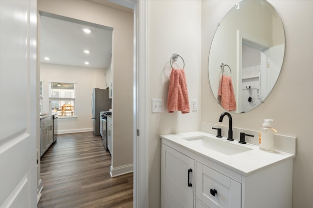 bathroom featuring hardwood / wood-style flooring and vanity