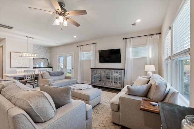 living room featuring ceiling fan and light hardwood / wood-style flooring