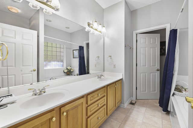 bathroom featuring vanity, shower with separate bathtub, a textured ceiling, and tile patterned floors