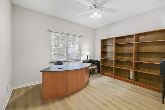 office area featuring ceiling fan, light hardwood / wood-style floors, and a textured ceiling