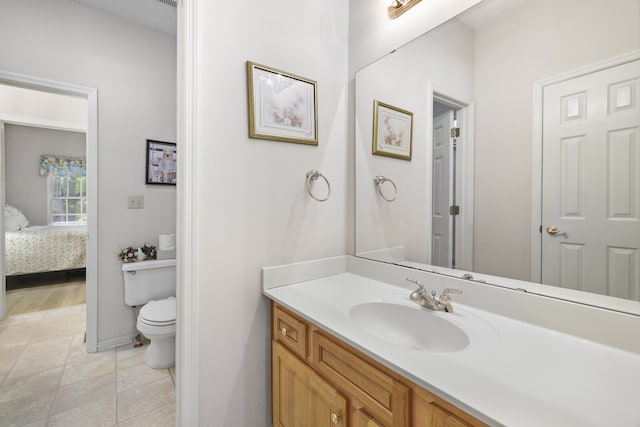 bathroom with tile patterned floors, vanity, and toilet