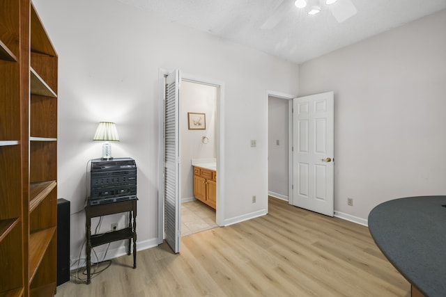 sitting room with light wood-type flooring and ceiling fan