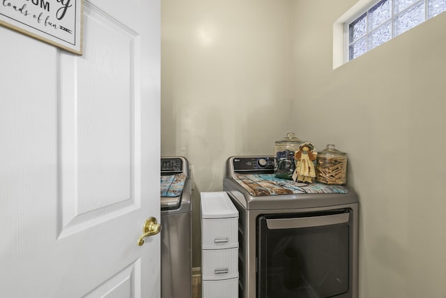 clothes washing area with washer and clothes dryer