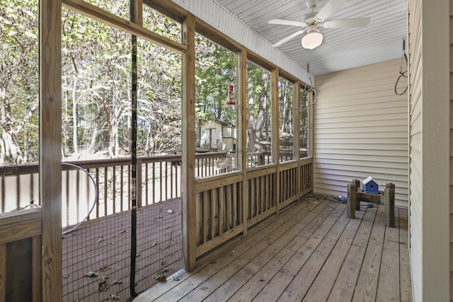 unfurnished sunroom with ceiling fan