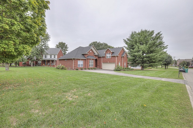 view of front of house with a garage and a front lawn