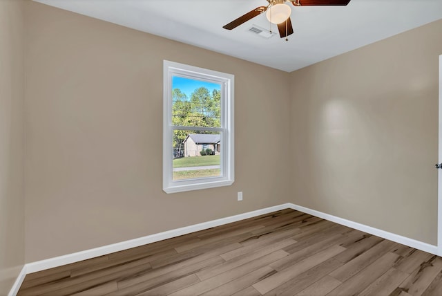 spare room with light hardwood / wood-style floors and ceiling fan