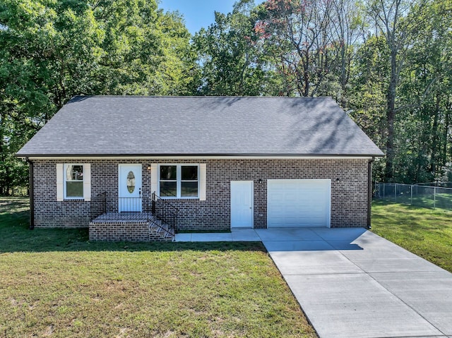 view of front of property with a front yard and a garage