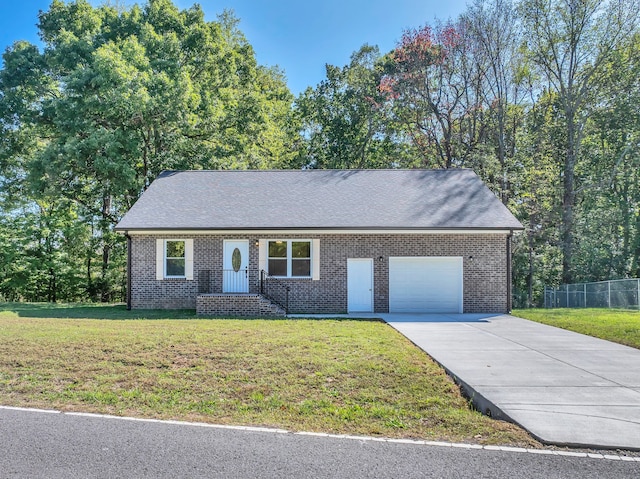 view of front of property featuring a garage and a front yard