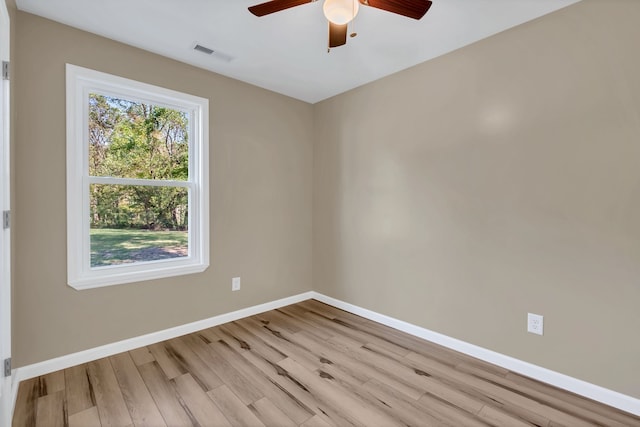 spare room with light wood-type flooring and ceiling fan