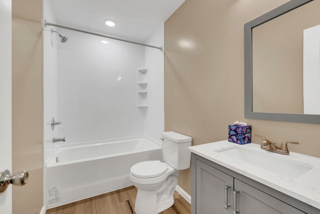 full bathroom with wood-type flooring, tub / shower combination, vanity, and toilet