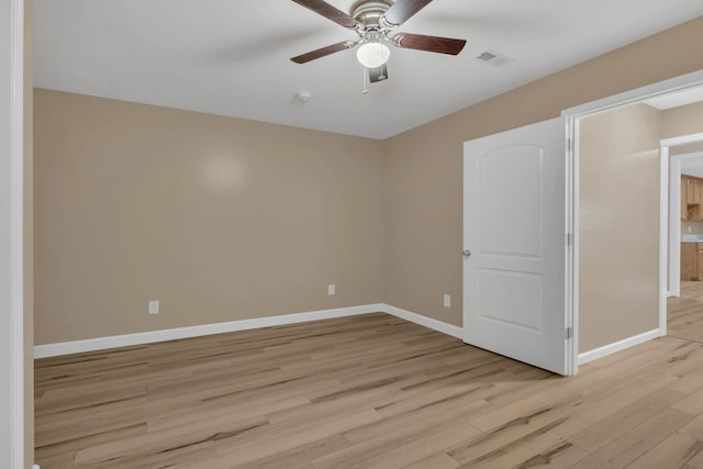 spare room featuring ceiling fan and light hardwood / wood-style floors