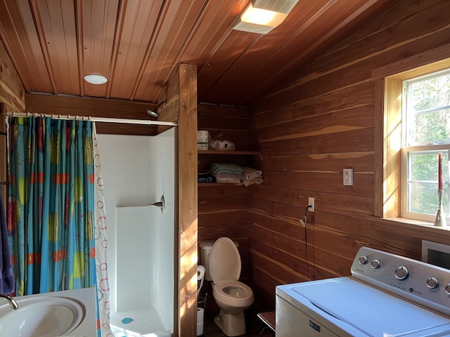 bathroom with curtained shower, wooden walls, washer / dryer, wooden ceiling, and toilet