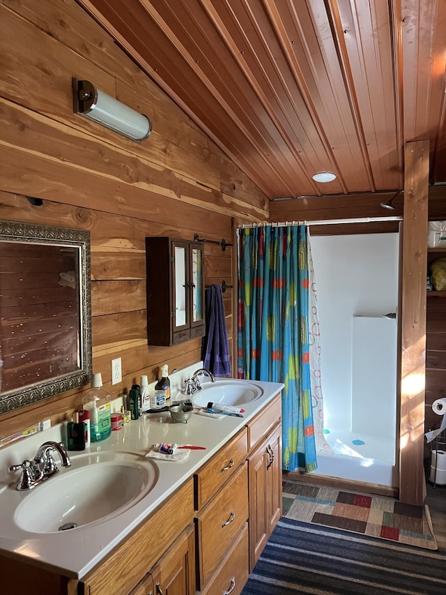 bathroom featuring wooden walls, vanity, wooden ceiling, a shower with shower curtain, and vaulted ceiling