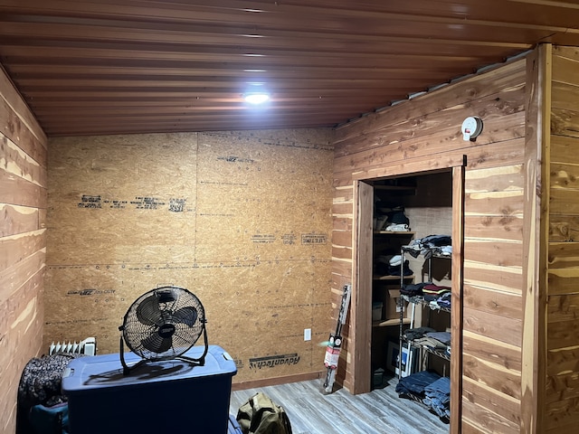 interior space with vaulted ceiling, hardwood / wood-style floors, and wooden ceiling