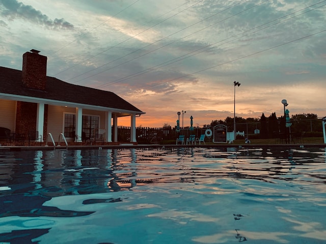 view of pool at dusk