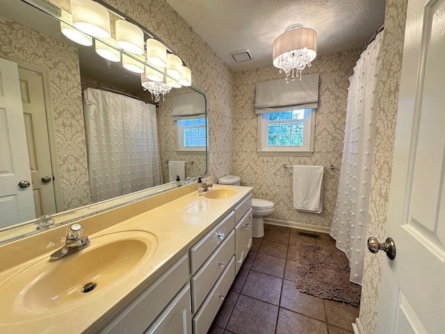 bathroom with vanity, tile patterned flooring, a chandelier, toilet, and a textured ceiling