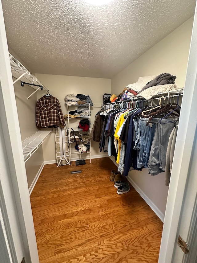 spacious closet featuring hardwood / wood-style floors