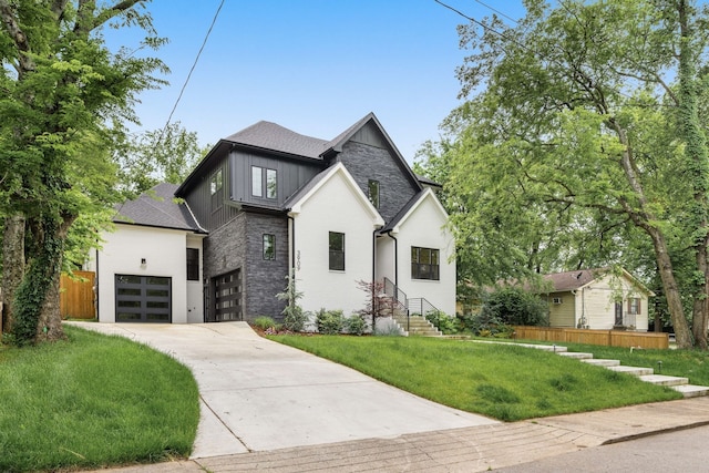 view of front of property with a front yard and a garage