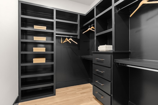 spacious closet with light hardwood / wood-style floors